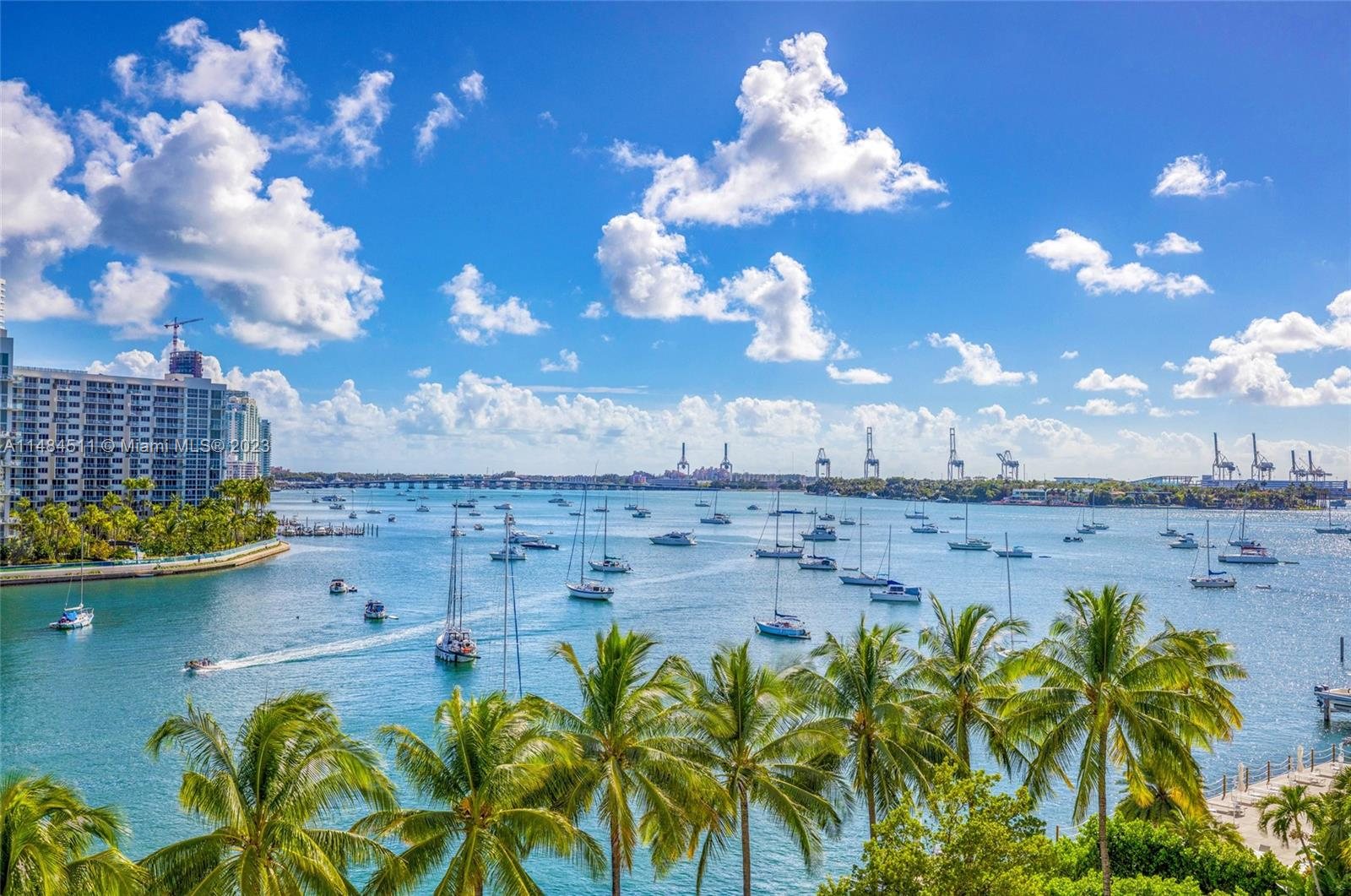Sailboats moored off Belle Isle, with the PortMiami cranes on the horizon