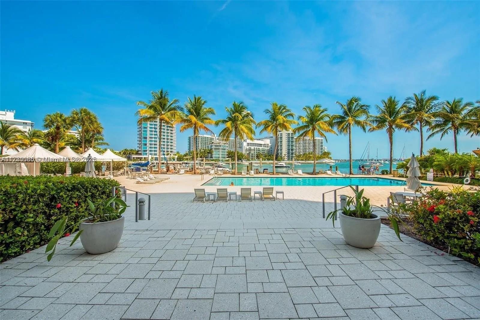 Pool deck with cabanas and the bay behind